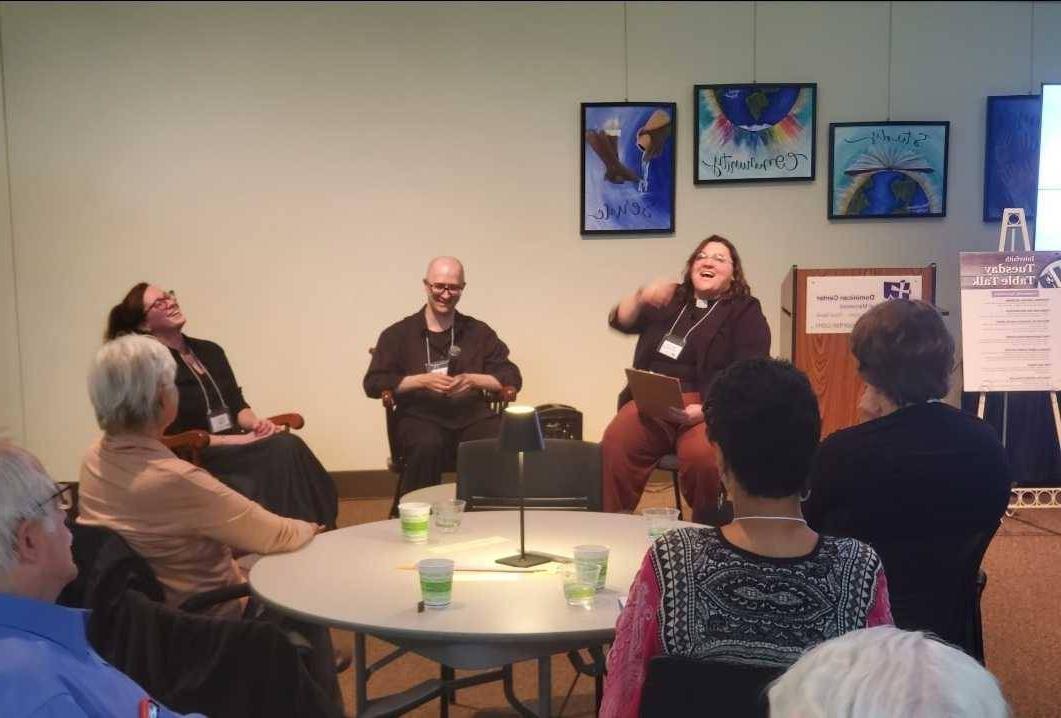 Panelists laughing together at a Tuesday Table Talk